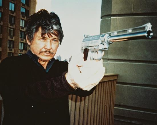 Charles Bronson holding the Wildey Survivor on a rooftop in a Death Wish 3 publicity photograph